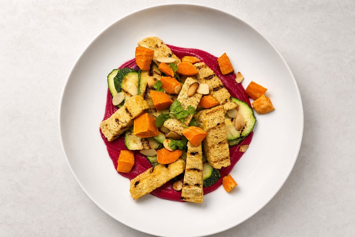 Courgette, sweet potato and tofu bowl with creamy beetroot sauce