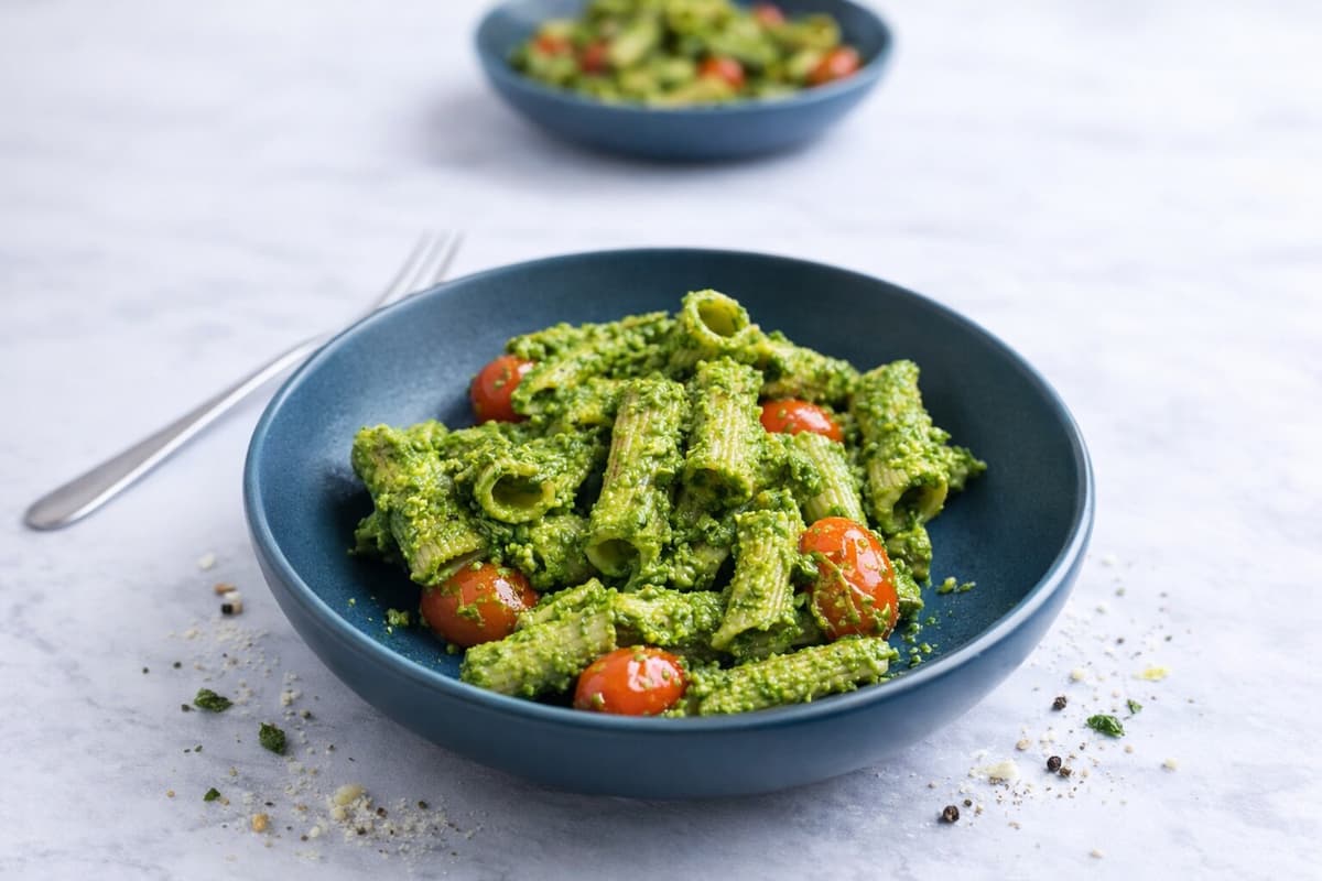Pasta with tomato and green pesto