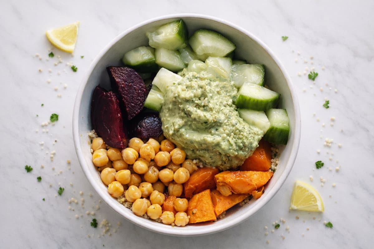 Quinoa, chickpea and green hummus salad bowl