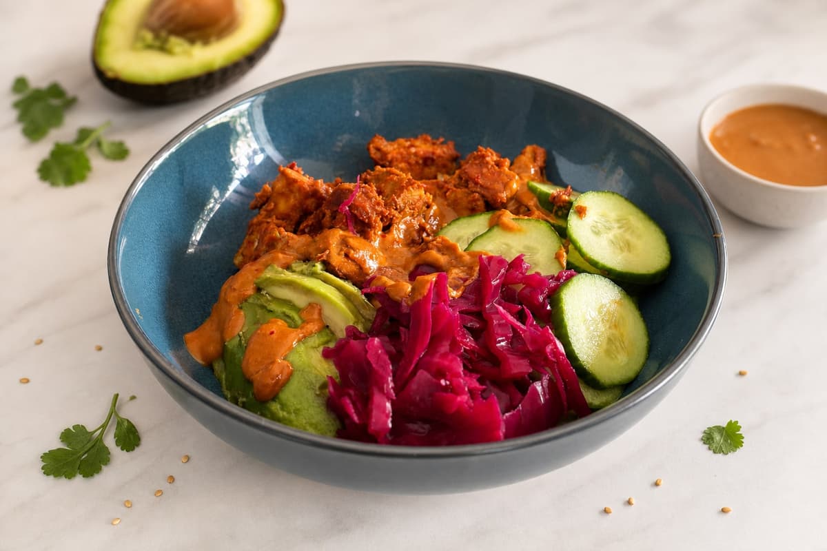 Tempeh grain bowl with spiced peanut sauce